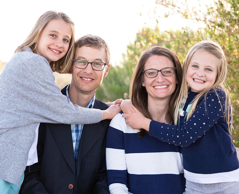 Family Photo young dog standing attentively next to owner in winter setting